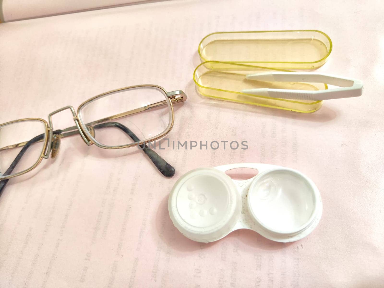 Set for contact lenses with a container, forceps, glasses. The concept of correcting myopia. Contact lens care, cleaning, health. Background, copy space