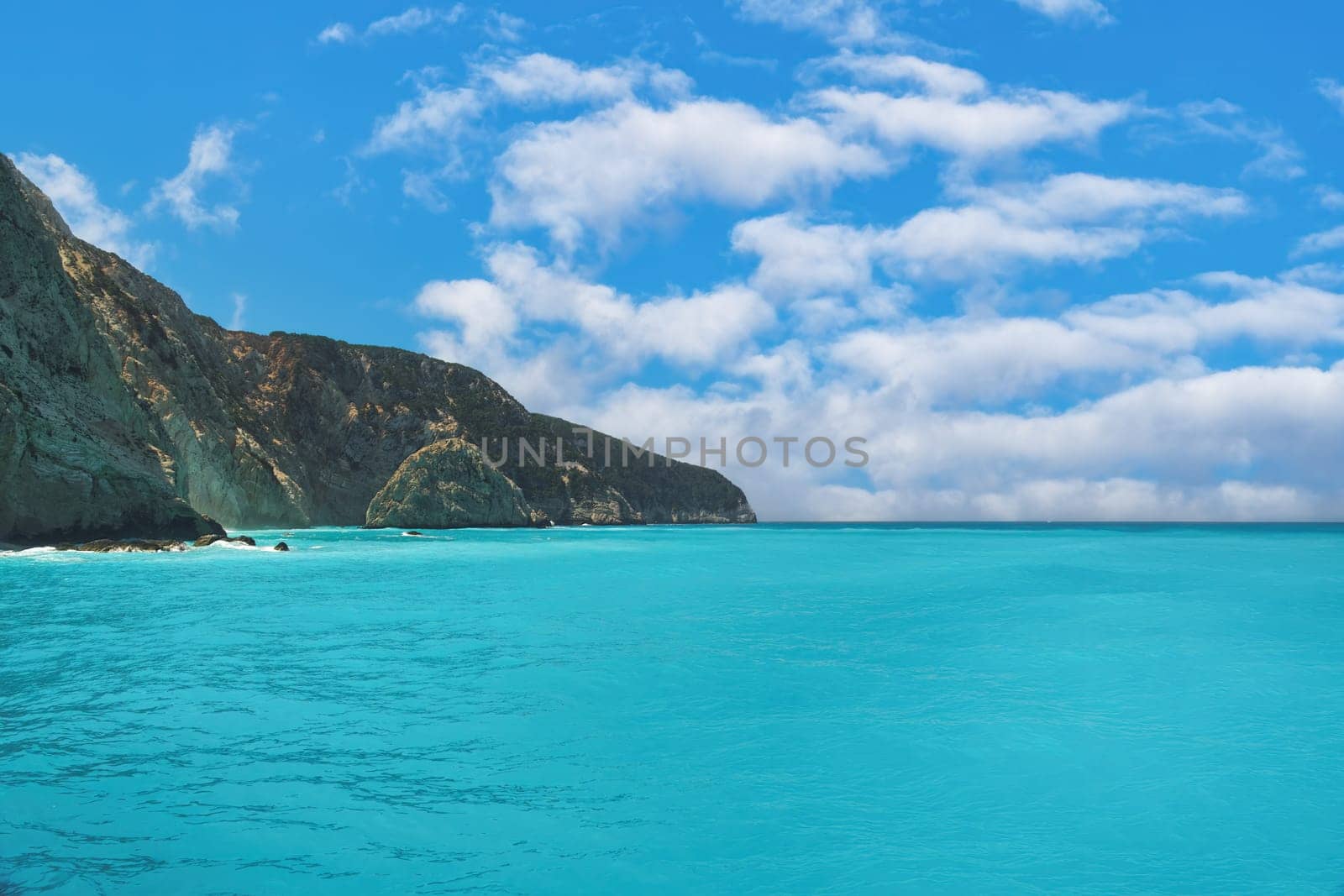 Crystal clear turquoise sea next to a rocky formation in Lefkada Ionian Island Geece.