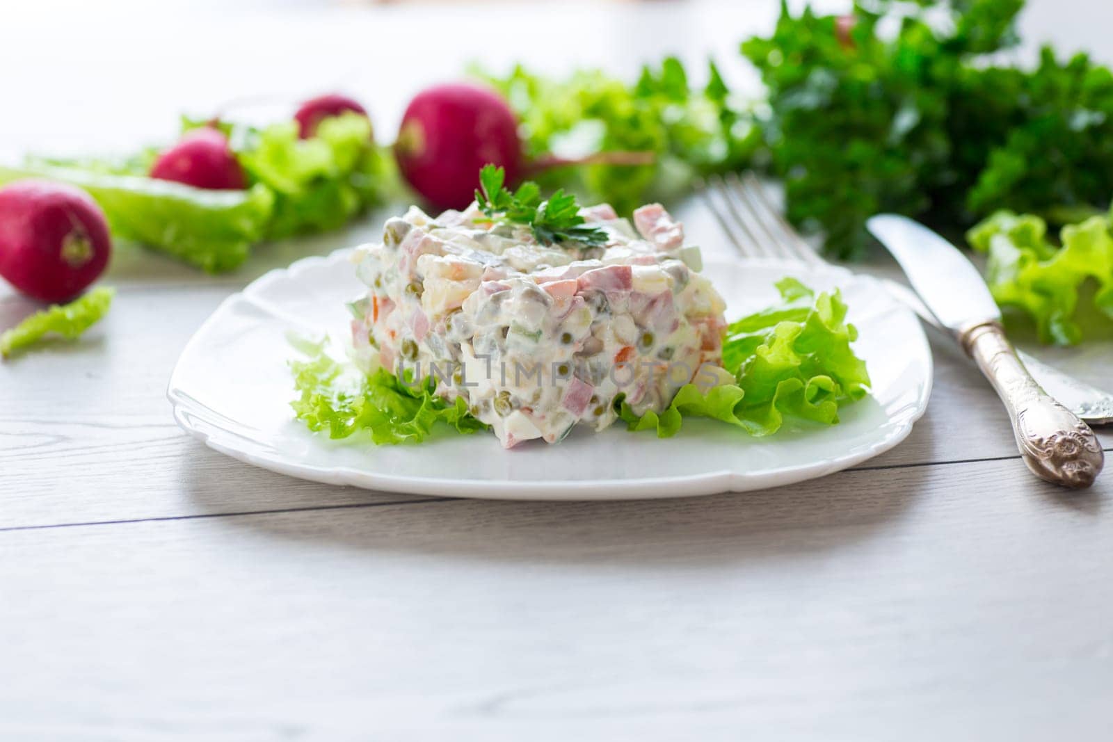 vegetable salad with boiled vegetables and dressed with mayonnaise .