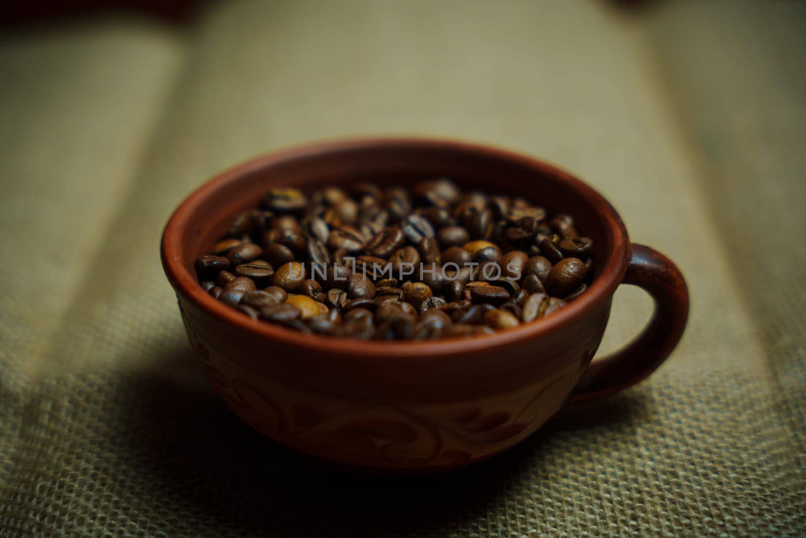 Coffee beans in a clay mug. High quality photo