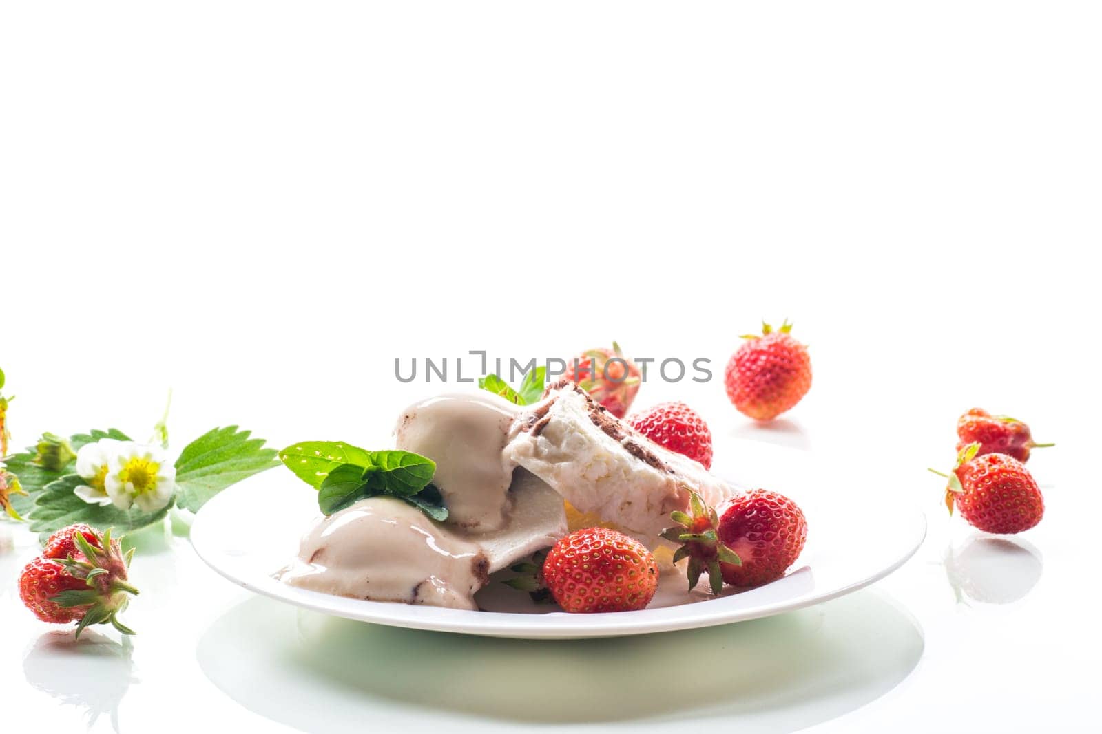 fresh organic cottage cheese with strawberries and ice cream in a plate isolated on white background .