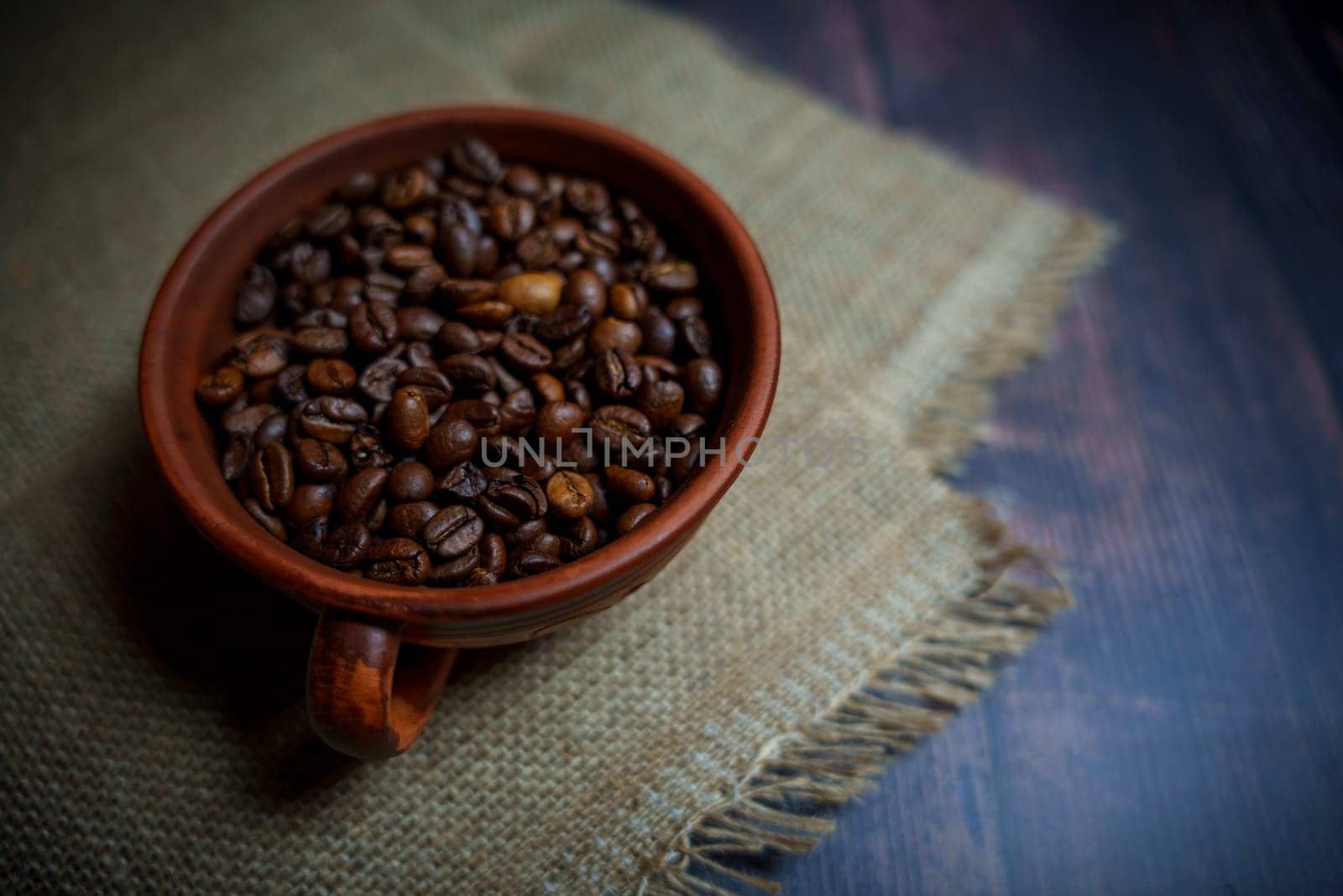 Coffee beans in a clay mug. High quality photo