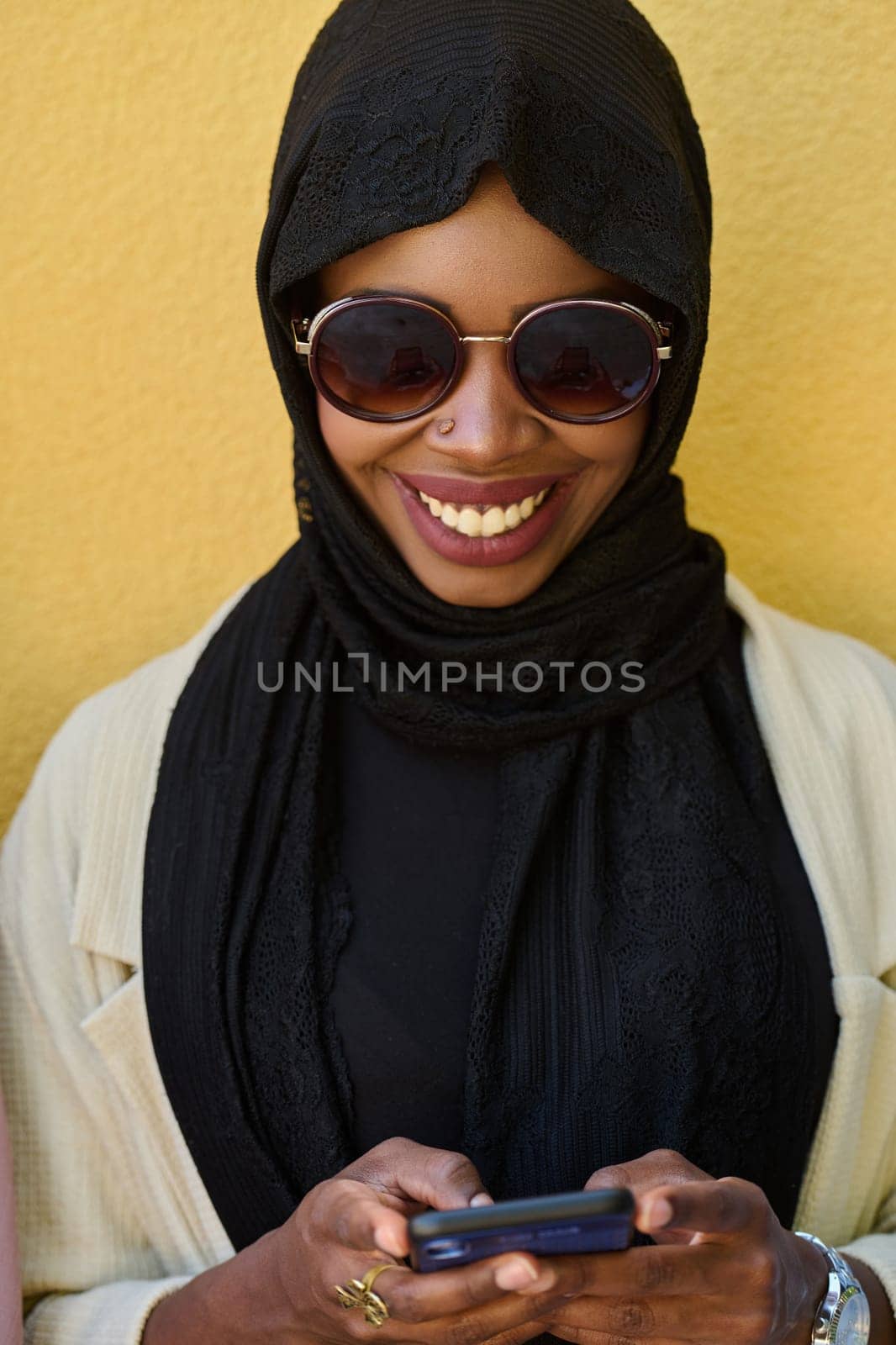 A close-up portrait captures the engagement of a Middle Eastern teenage Muslim girl in her digital world, as she uses a smartphone with focused attention