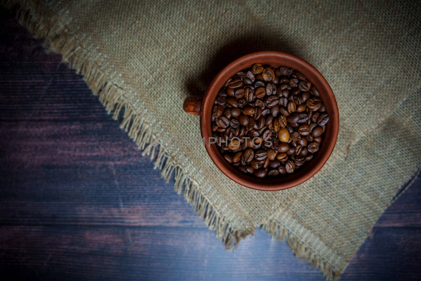 Coffee beans in a clay mug. High quality photo