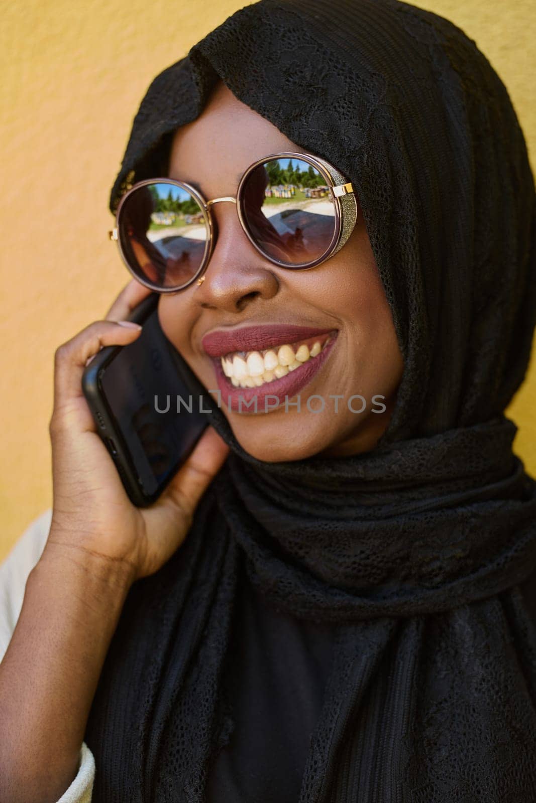 A close-up portrait captures the engagement of a Middle Eastern teenage Muslim girl in her digital world, as she uses a smartphone with focused attention