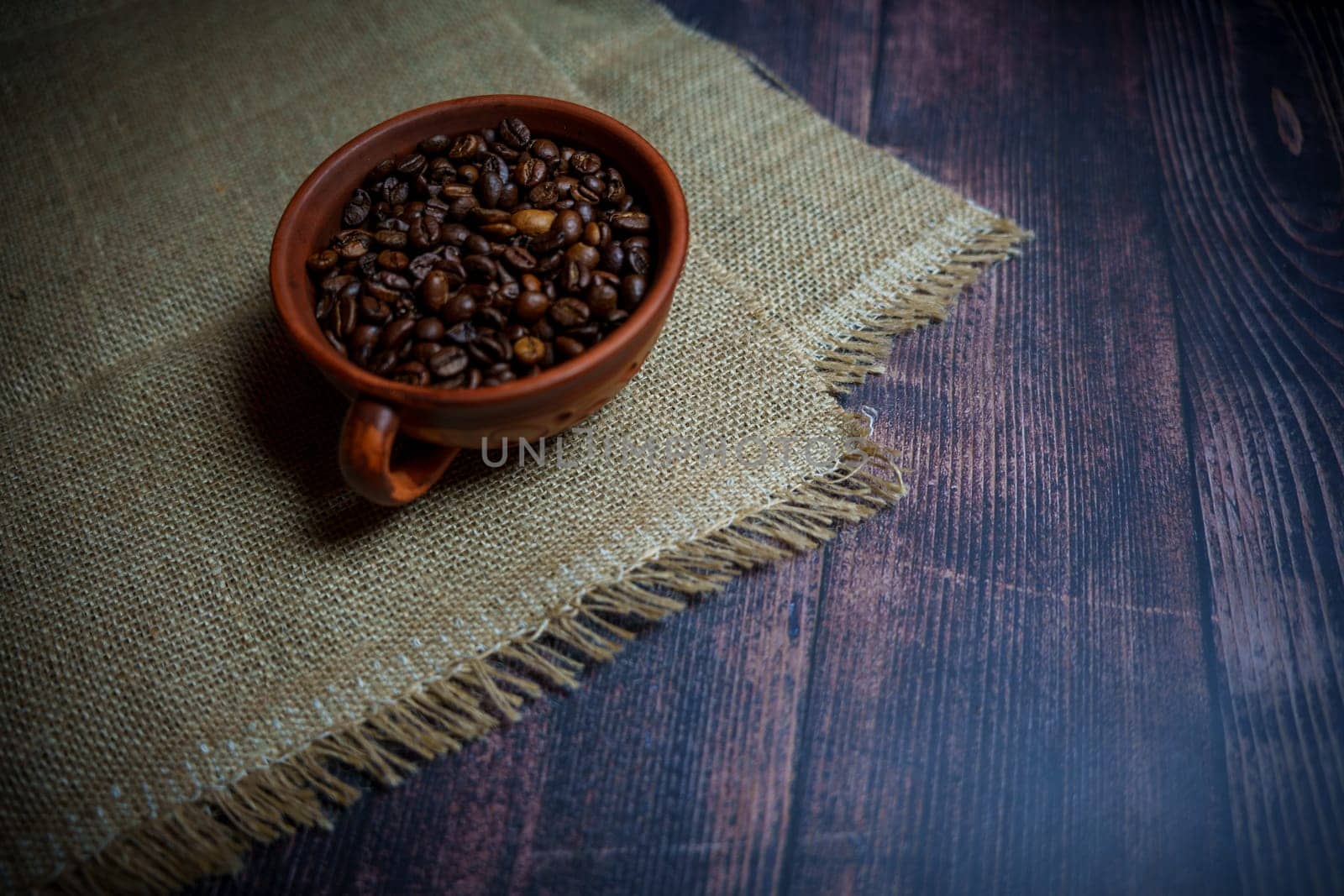 Coffee beans in a clay mug. High quality photo