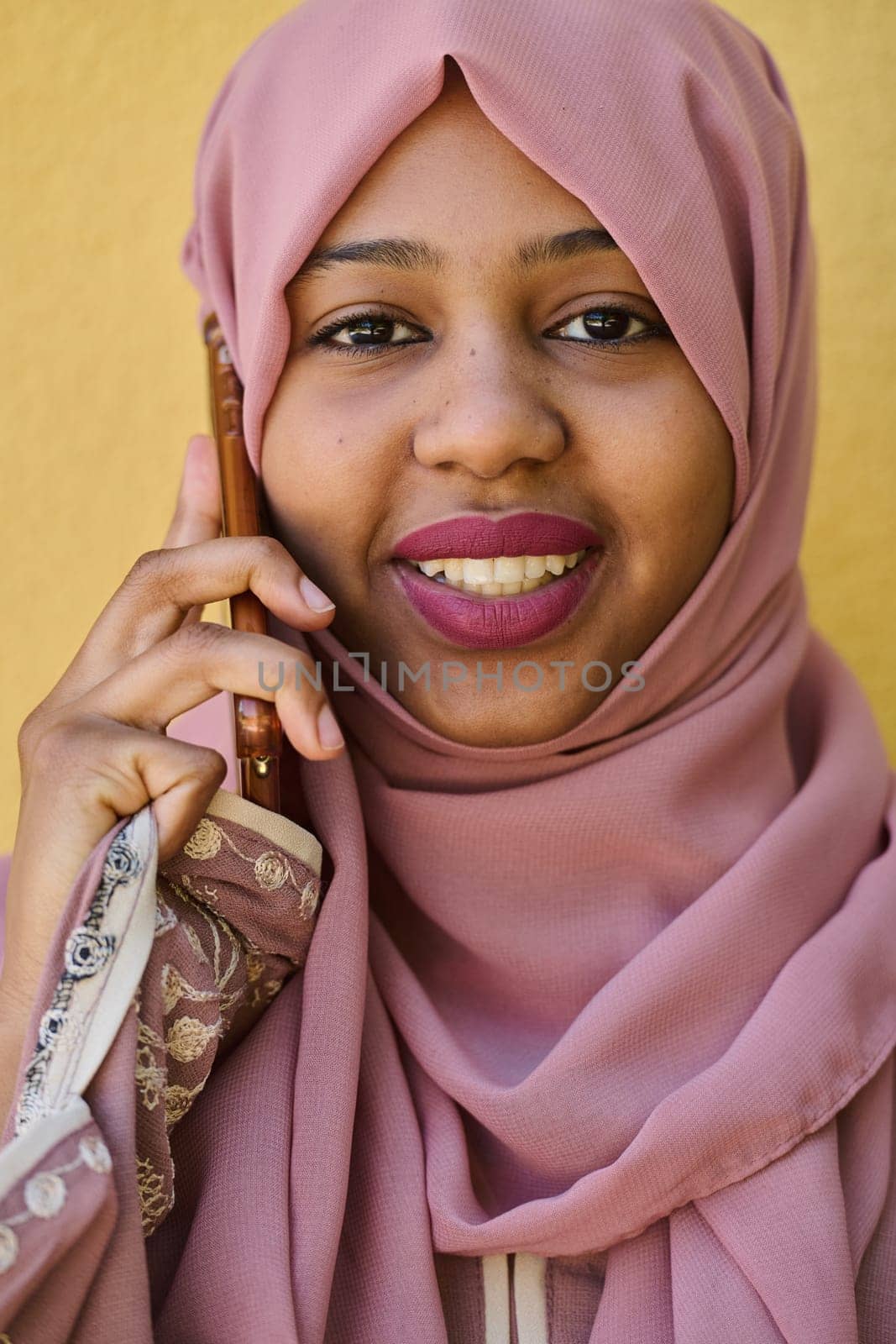 A close-up portrait captures the engagement of a Middle Eastern teenage Muslim girl in her digital world, as she uses a smartphone with focused attention