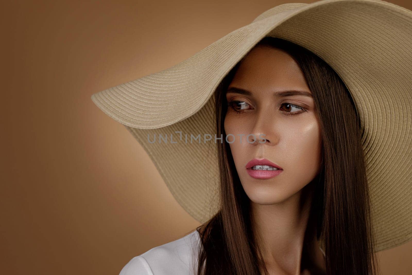 Portrait of young woman in fashionable summer hat. copy space