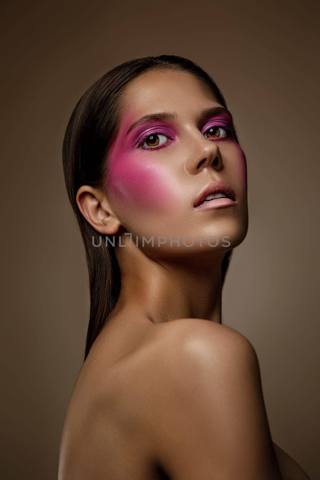 Fashion art skin woman face portrait, closeup. Glamour shiny professional makeup girl with trendy pink make-up