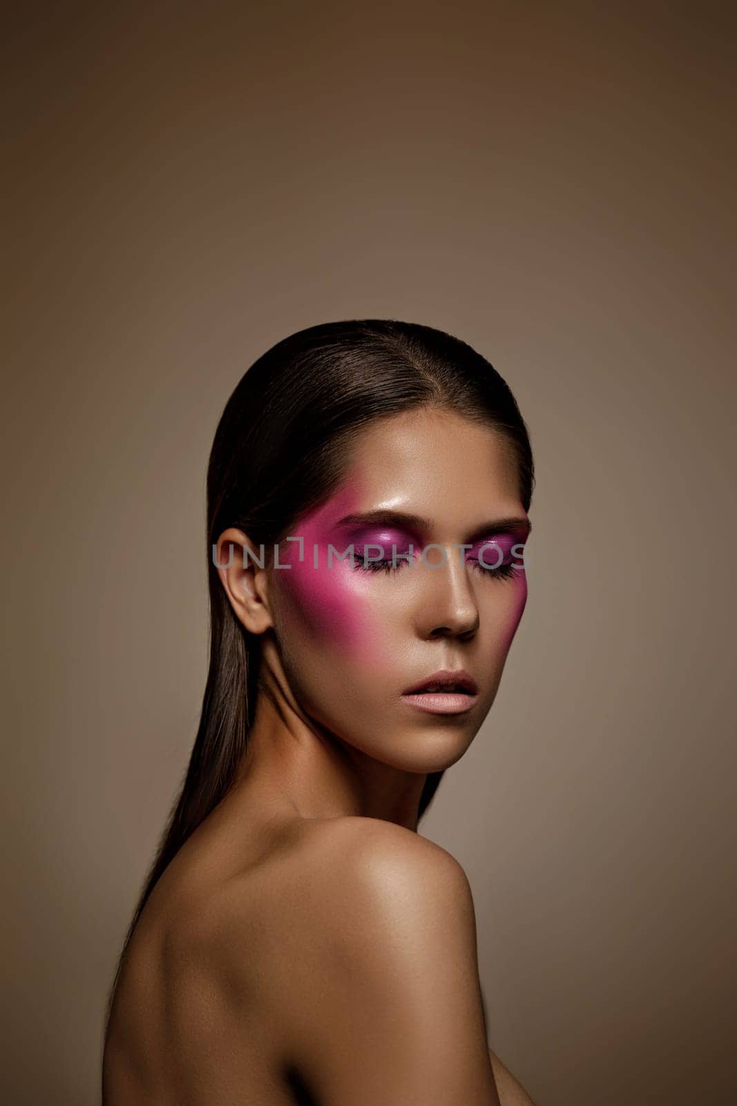 Fashion art skin woman face portrait, closeup. Glamour shiny professional makeup girl with trendy pink make-up