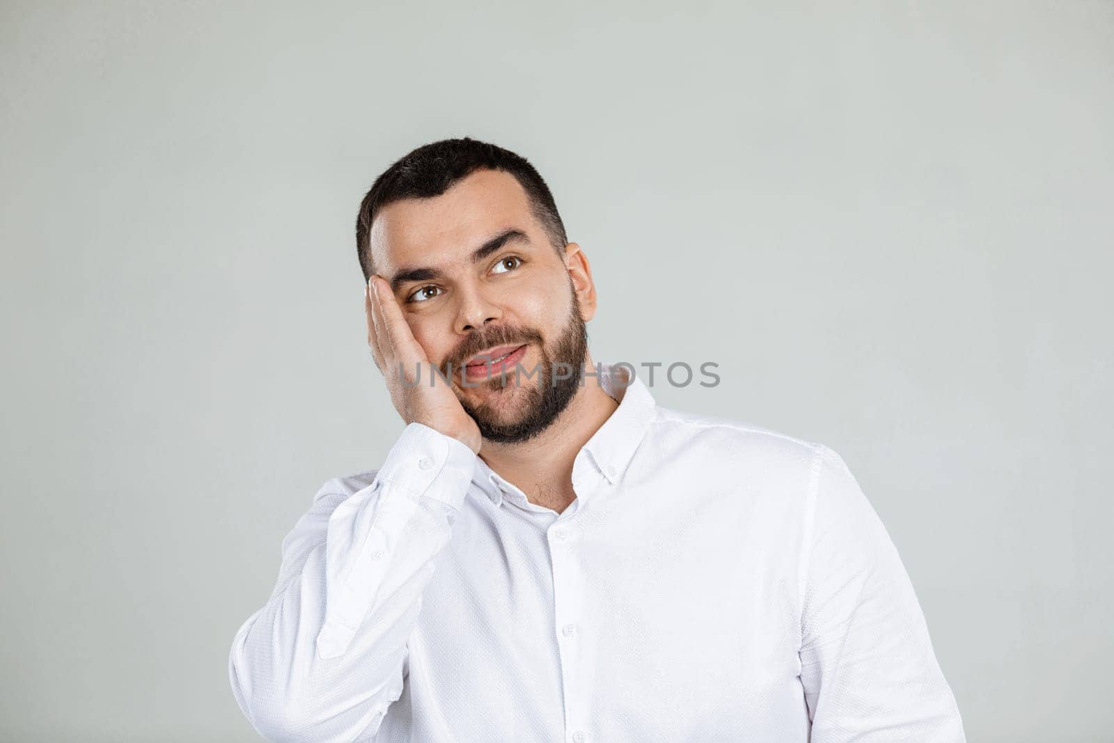 bearded minded happy young man dreaming about something