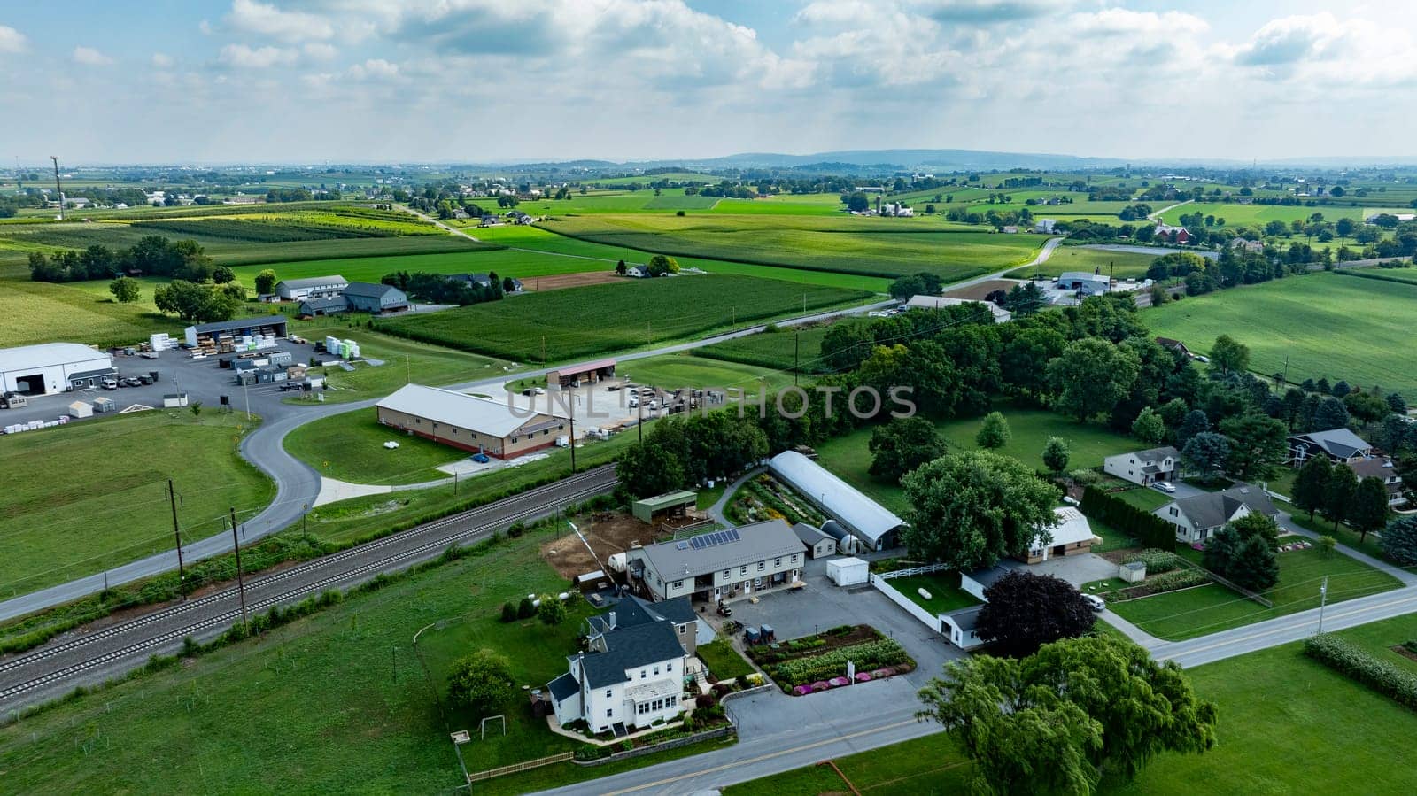 An Aerial View of Rural Community with Farms, Homes, and Industrial Area