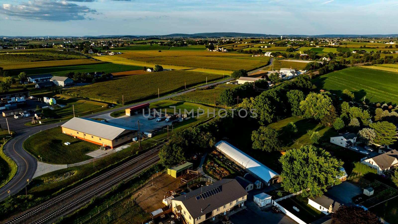 An Aerial View of Rural Community with Homes, Gardens, and Farmland