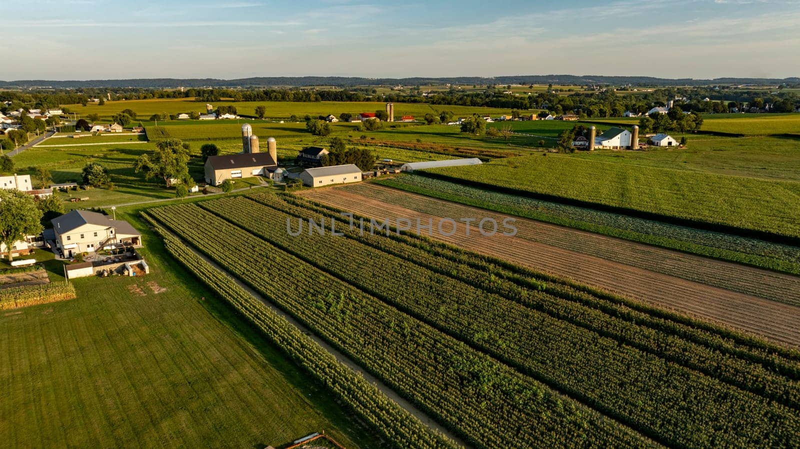 An Aerial View of Rural Farmland and Buildings at Dusk