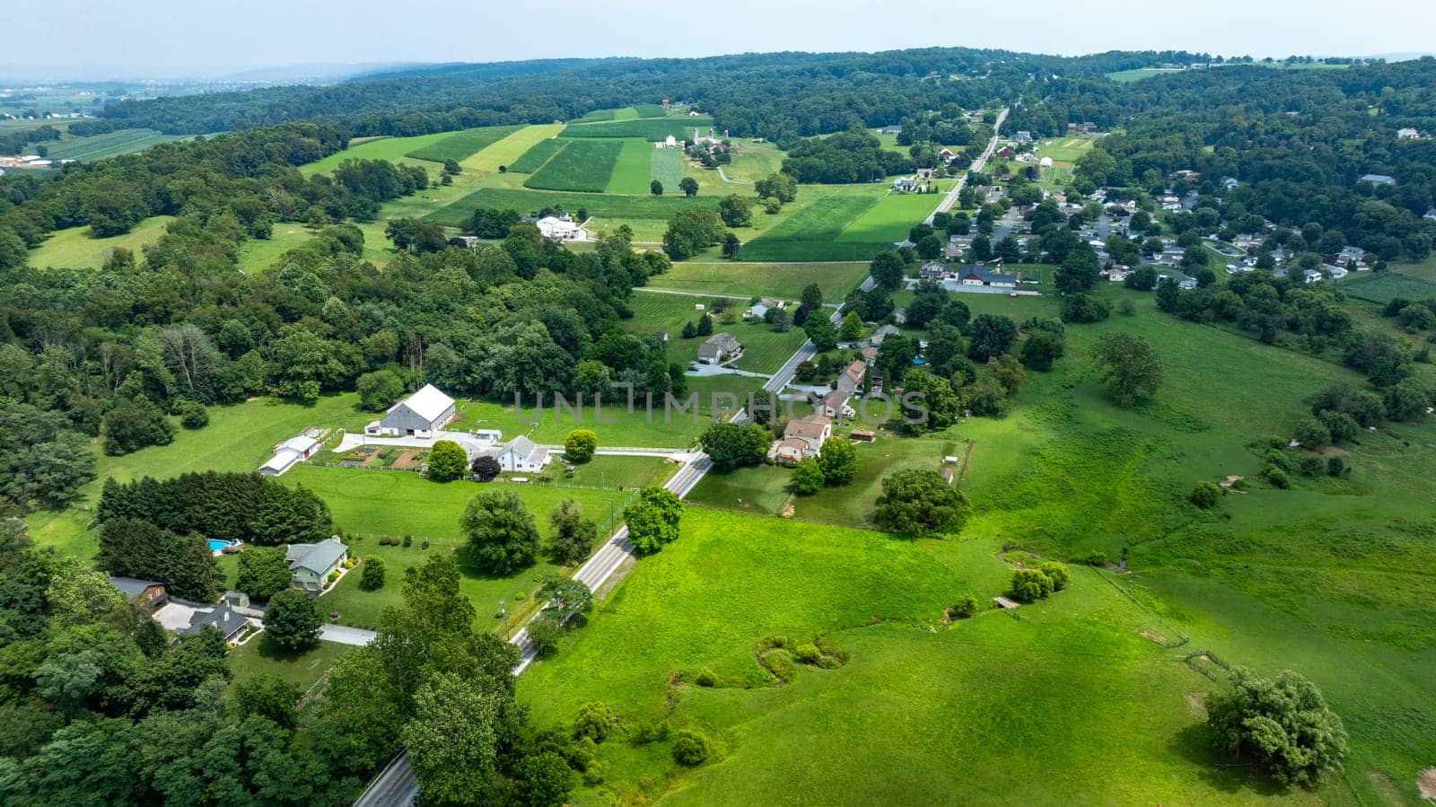 An Aerial View of Rural Homesteads and Lush Farmlands