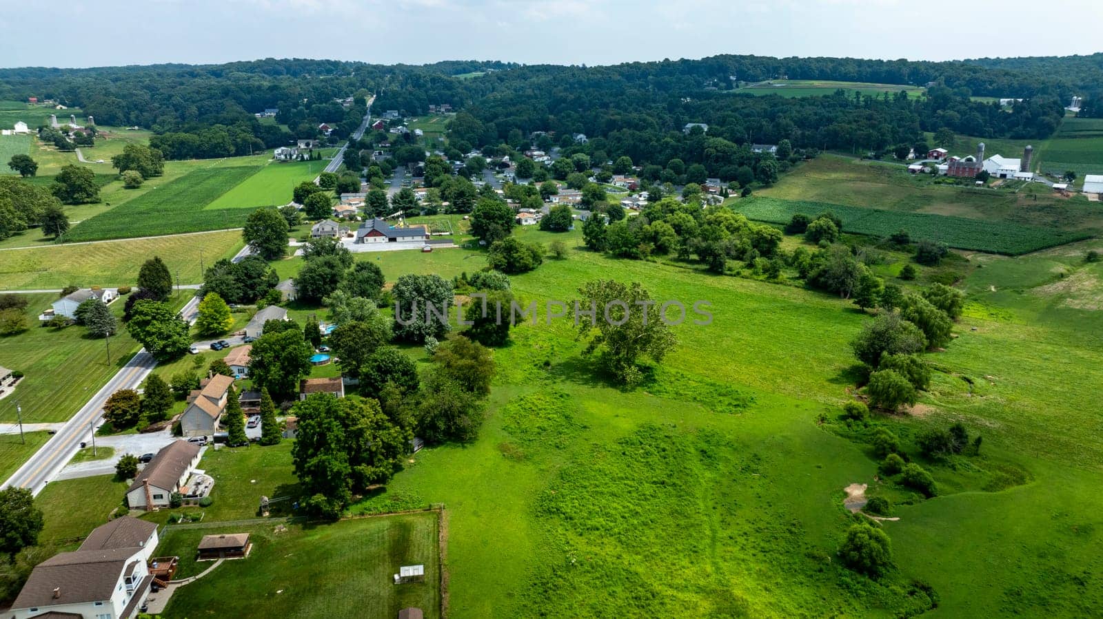 An Aerial View of Rural Community and Surrounding Farmlands