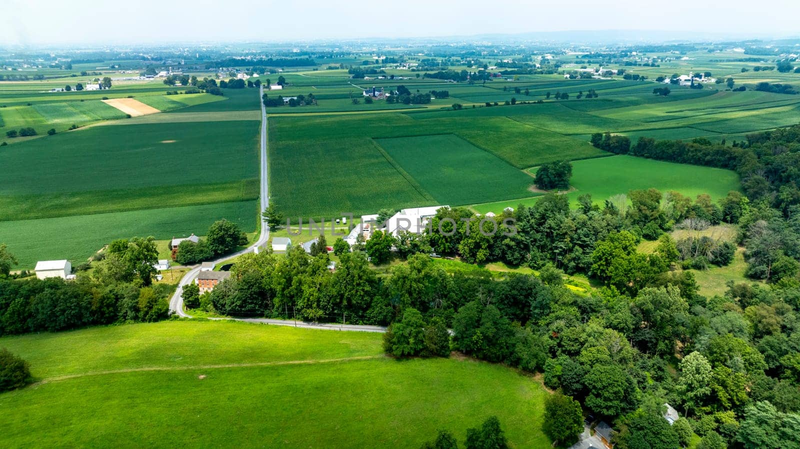 An Aerial View of Expansive Farmlands and Country Roads