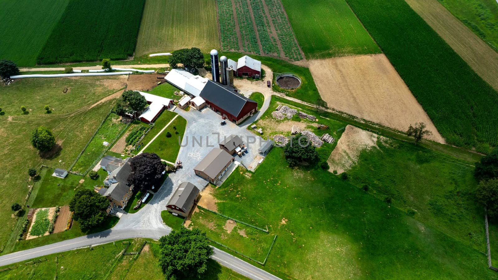 Paradise, Pennsylvania, USA, July 18. 2023 - An Aerial View of Rural Farmstead and Agricultural Fields