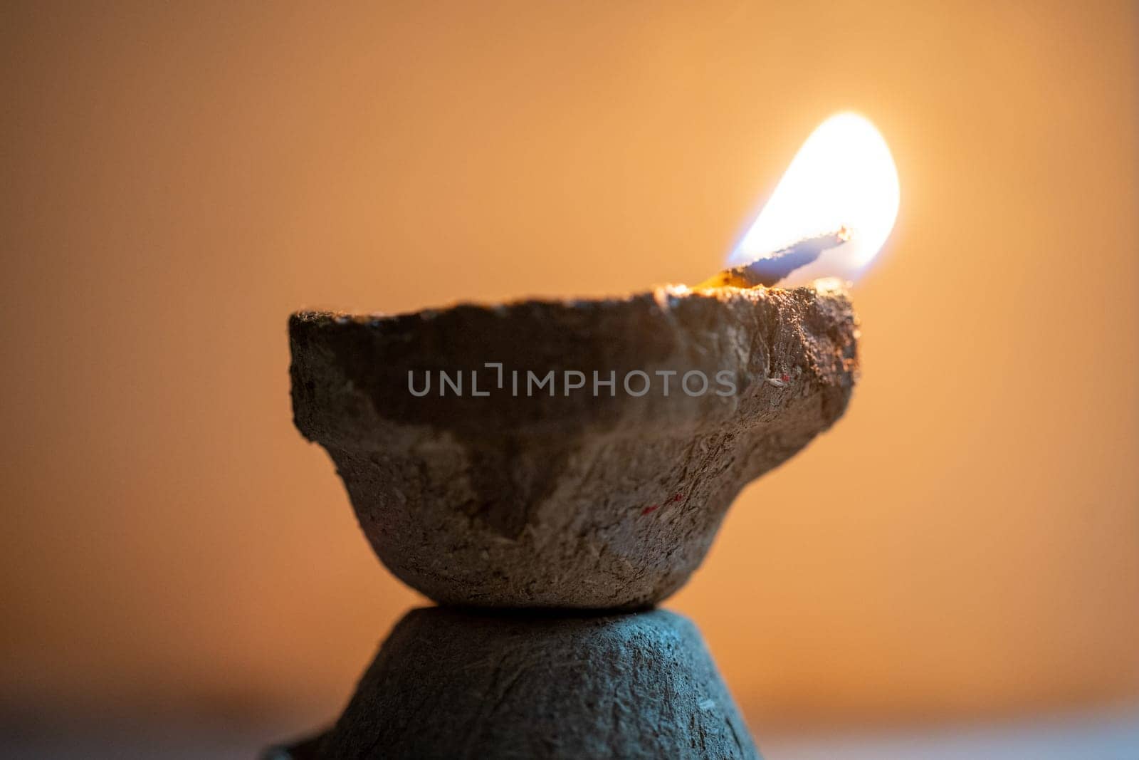 Organic diya lamp made of organic coconut fiber filled with oil and lit to provide light and as an offering to the hindu gods on the festival of diwali by Shalinimathur