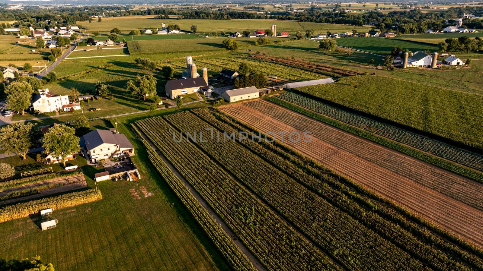 An Aerial View of Rural Farmland and Community at Sunset