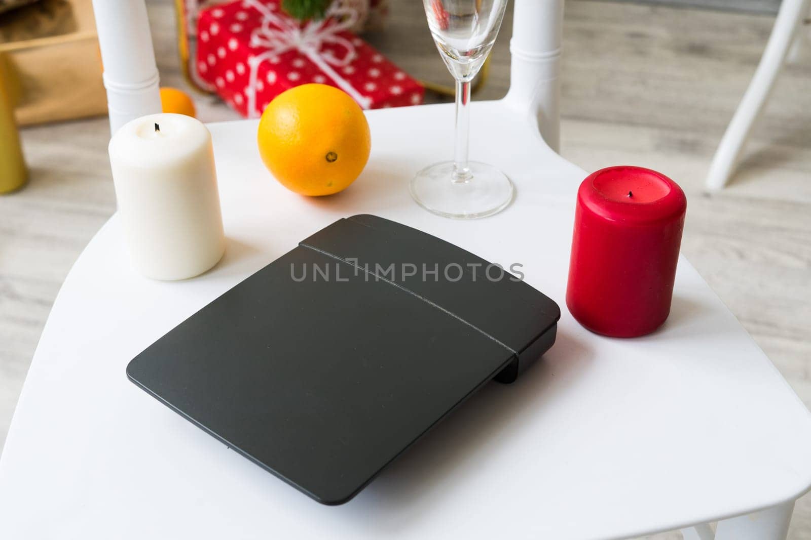 Internet router modem and Christmas decor on a white chair background