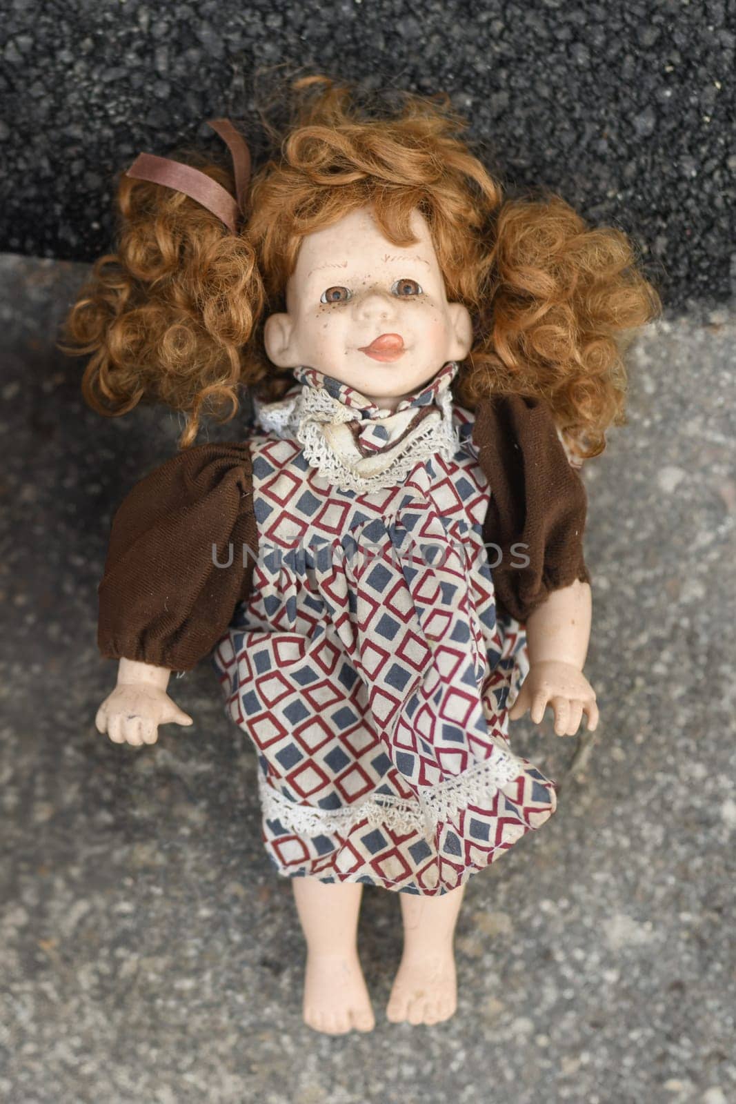 Dirty doll in dust at the flea market in France