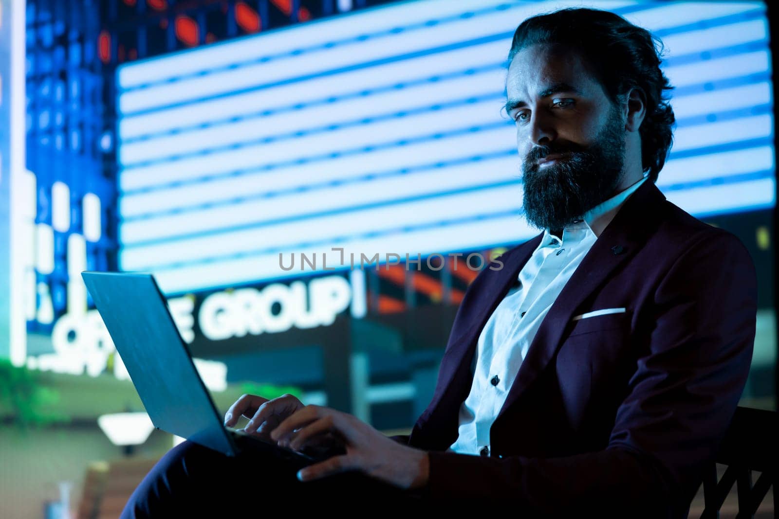 Business owner in suit working after hours in the city center, following stock market trends online to check capital investment updates. Influential company CEO reading financial reports.