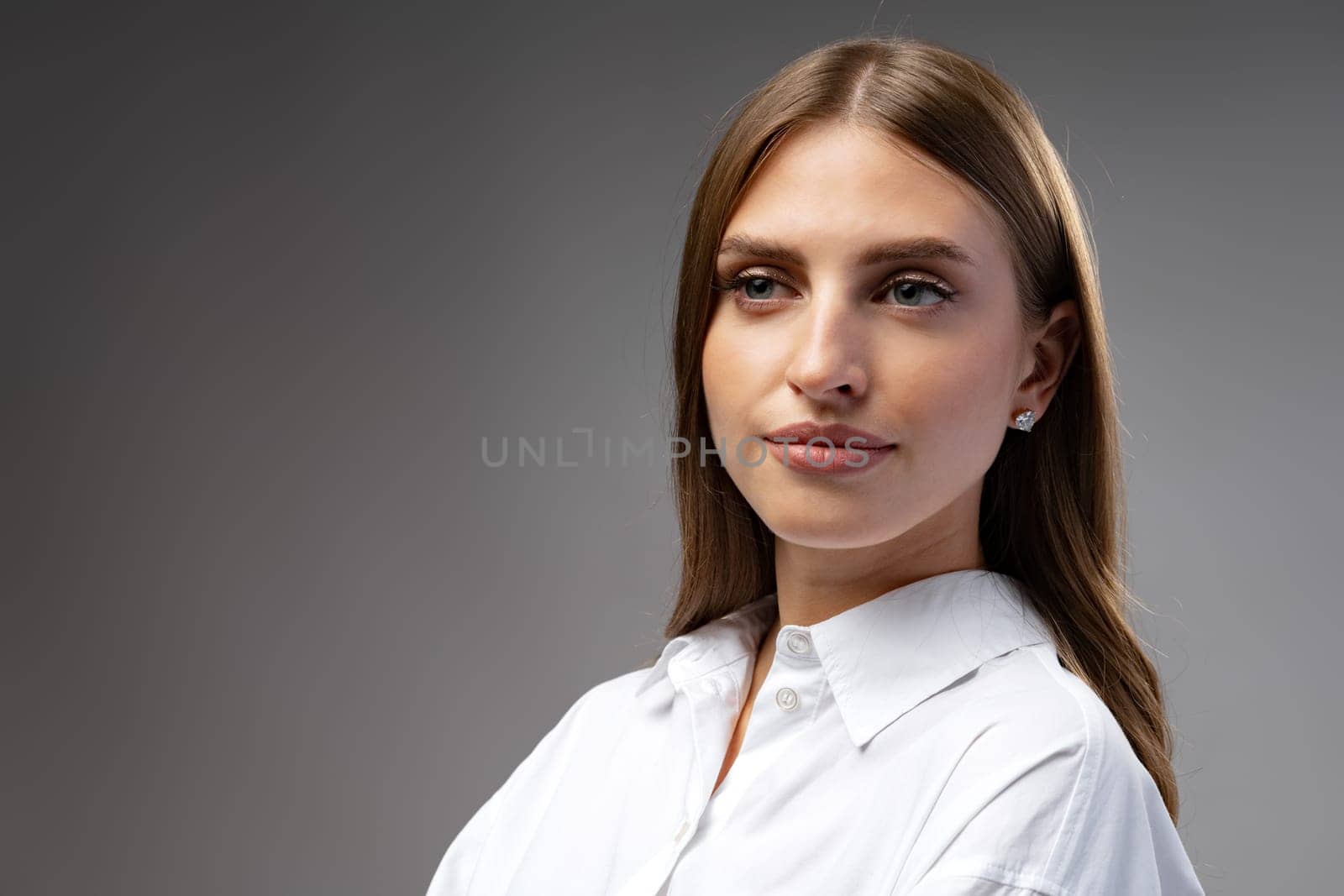 Thoughtful businesswoman portrait on a dark gray background close up