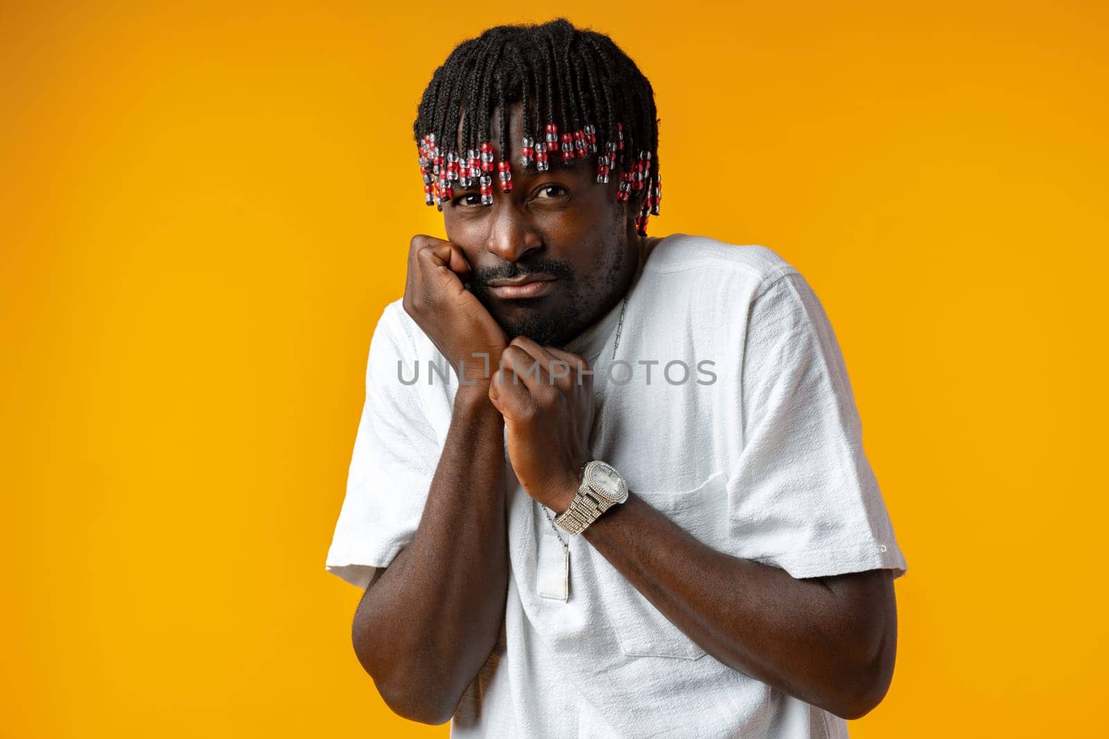 Scared african man face over yellow background in studio