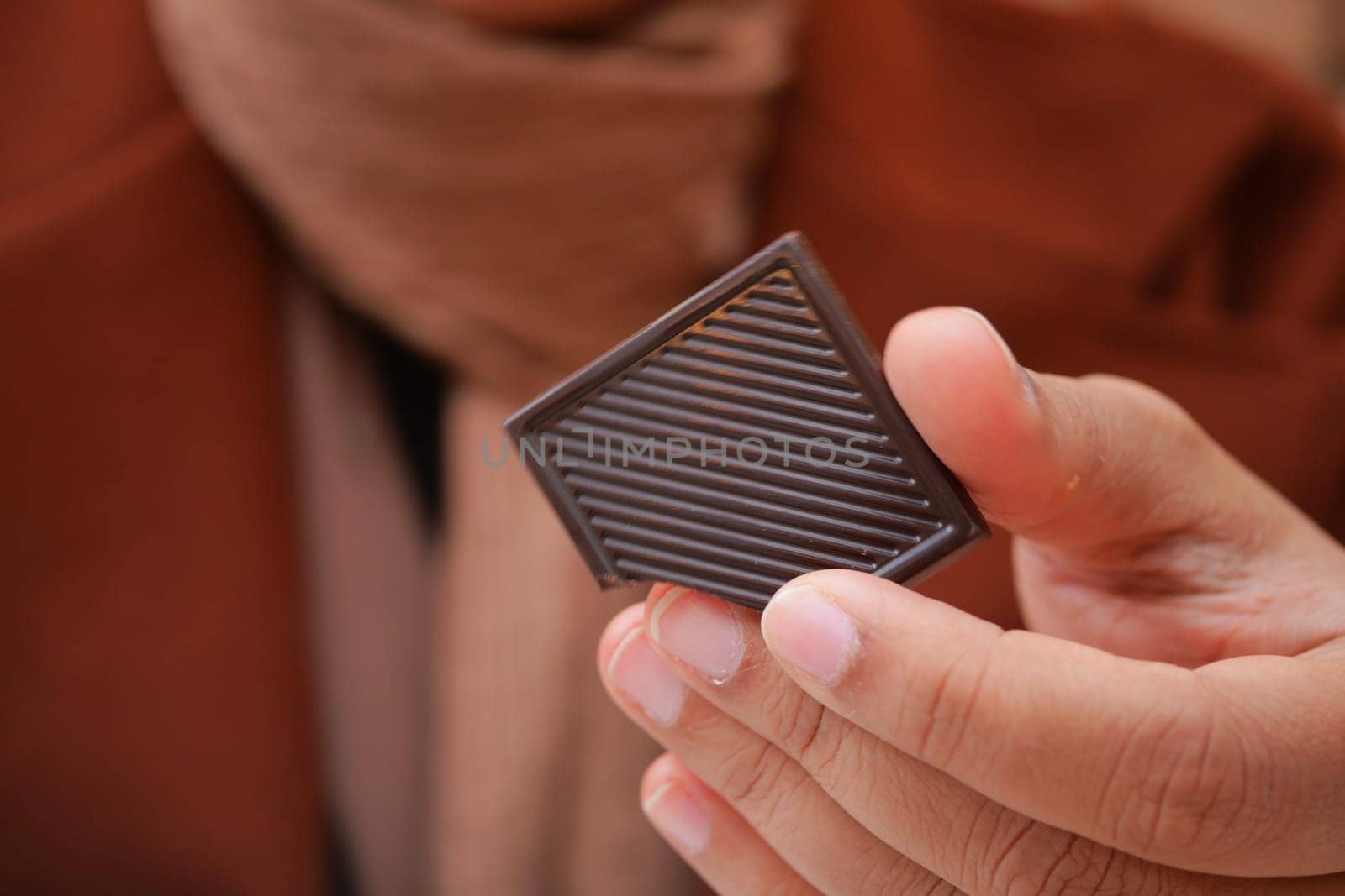 Closeup of woman eating chocolate candy