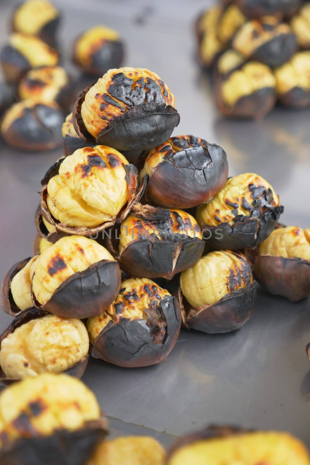 traditional Istanbul street food grilled chestnuts in a row.