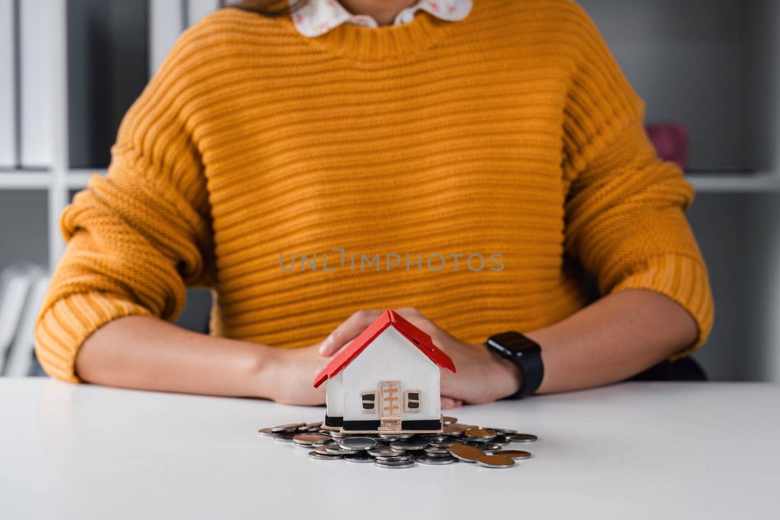 Real estate or property investment. home mortgage loan rate. saving money for retirement concept. Coin stack on international banknotes with house model on table. business growth background.