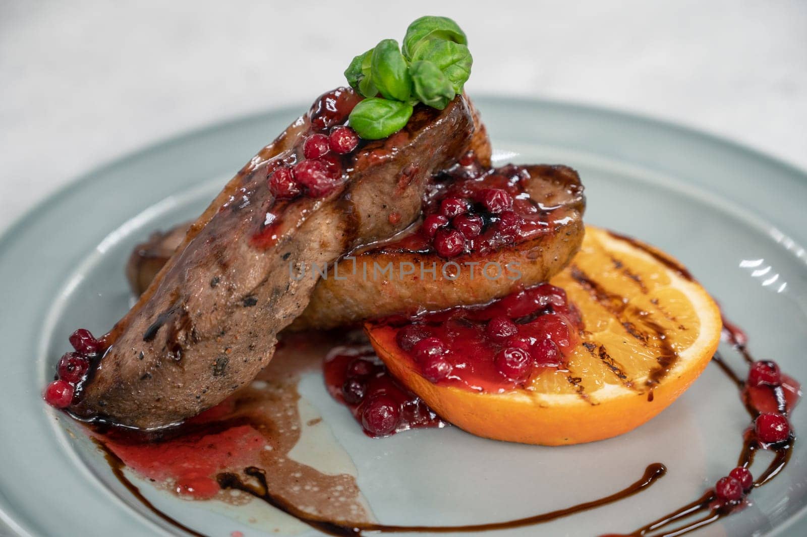 Tasty duck breast with orange and berries