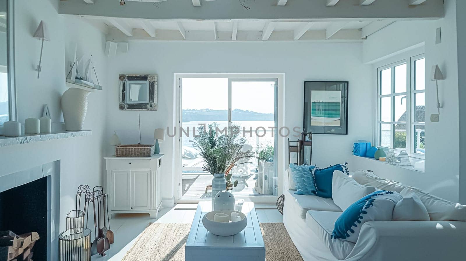 Interior of a living room with white walls, sofa and cushions. Sitting room in coastal cottage with sea view. Luxury lounge room