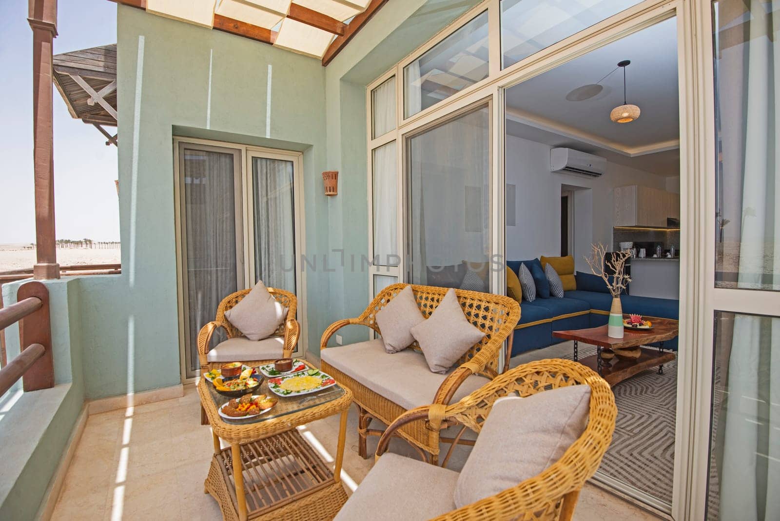 Terrace furniture of a luxury apartment in tropical resort with furniture and sea view from balcony with al fresco dining