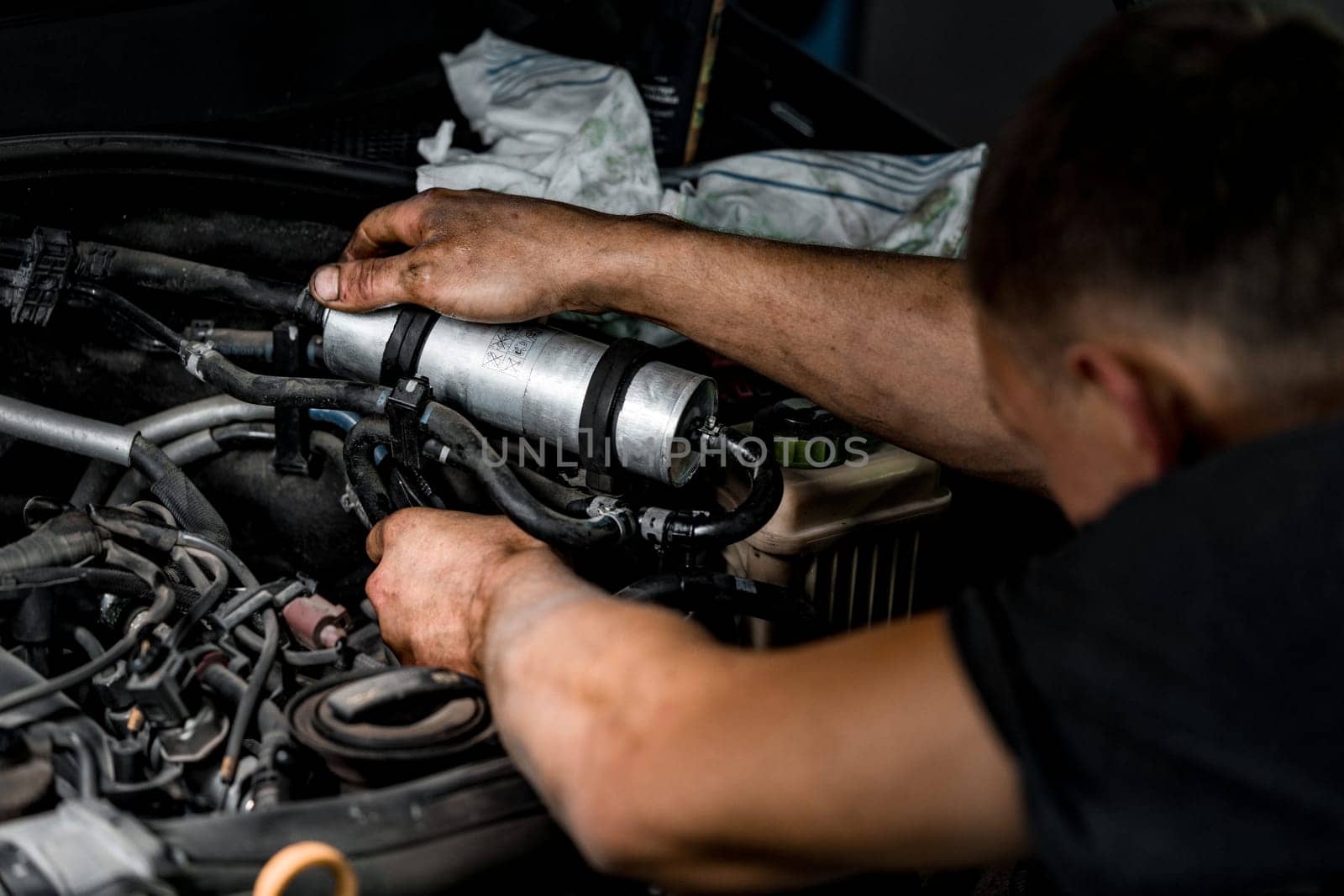 Close up photo of auto mechanic repairing car engine in car service