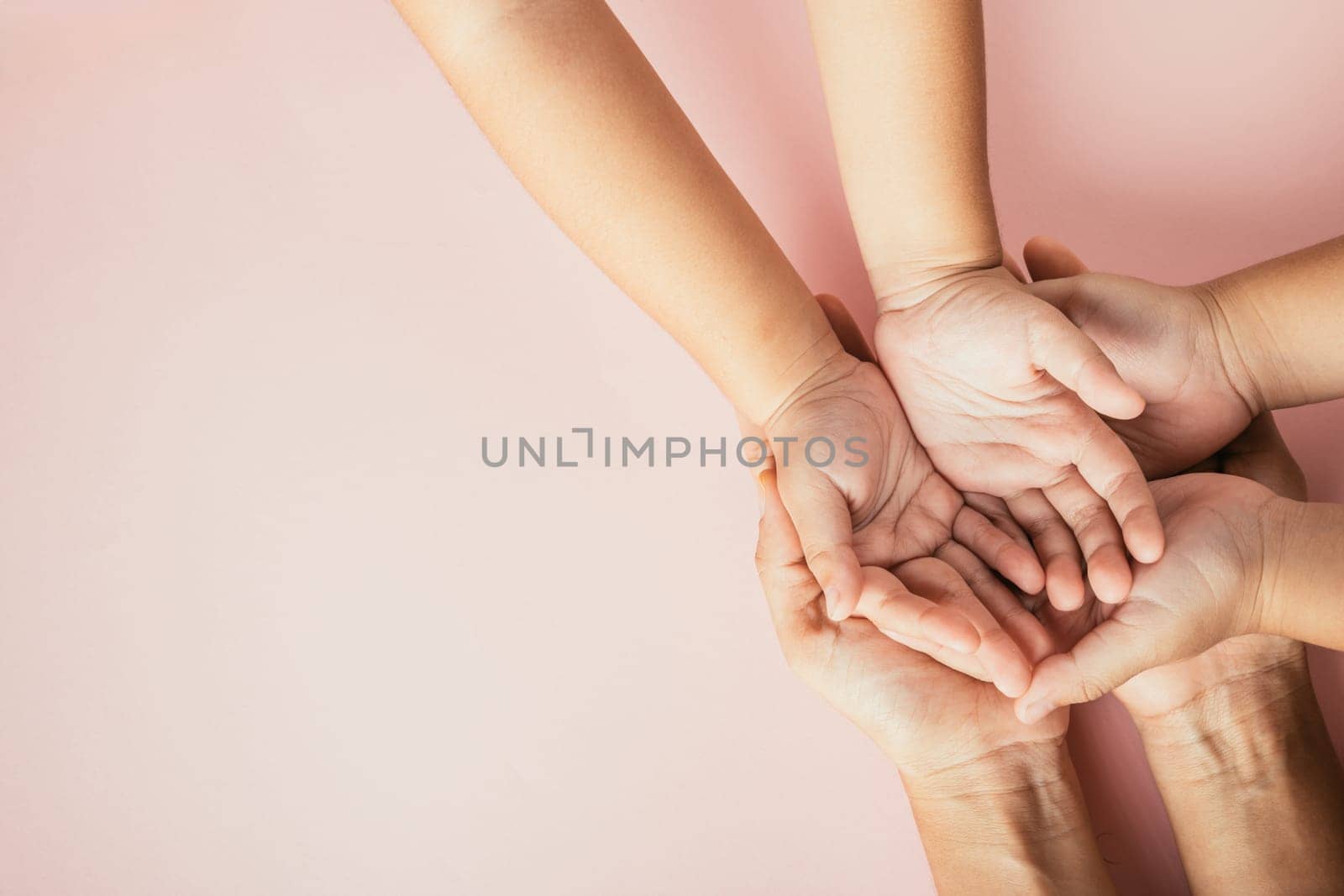 Family day celebration, Top view of parents and kid holding empty hands together isolated on color background. Space for text.