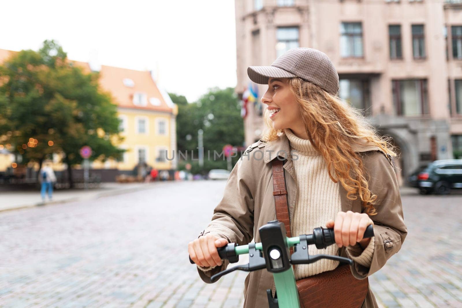 Young woman standing on electric scooter in the city, close up