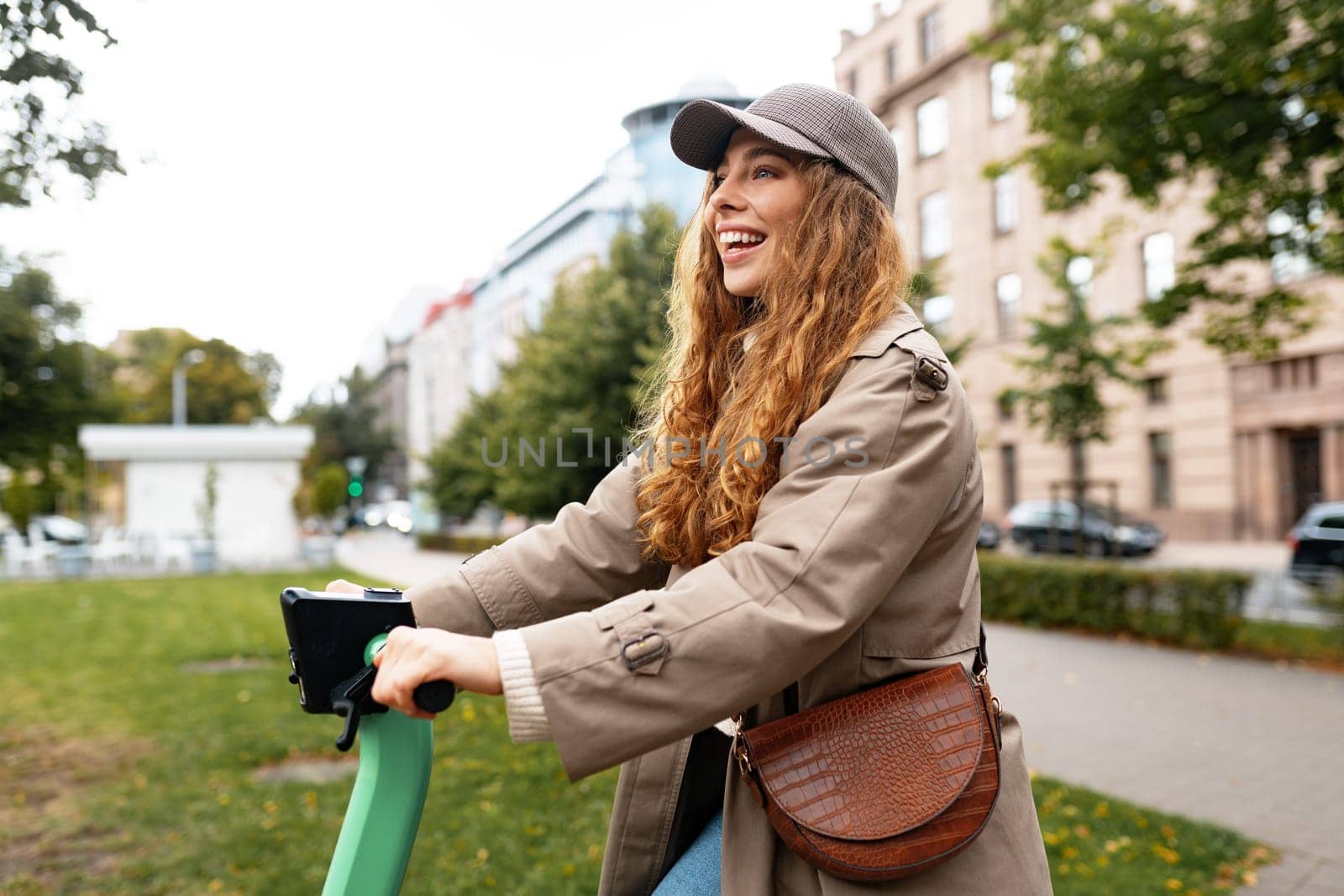 Young woman standing on electric scooter in the city, close up