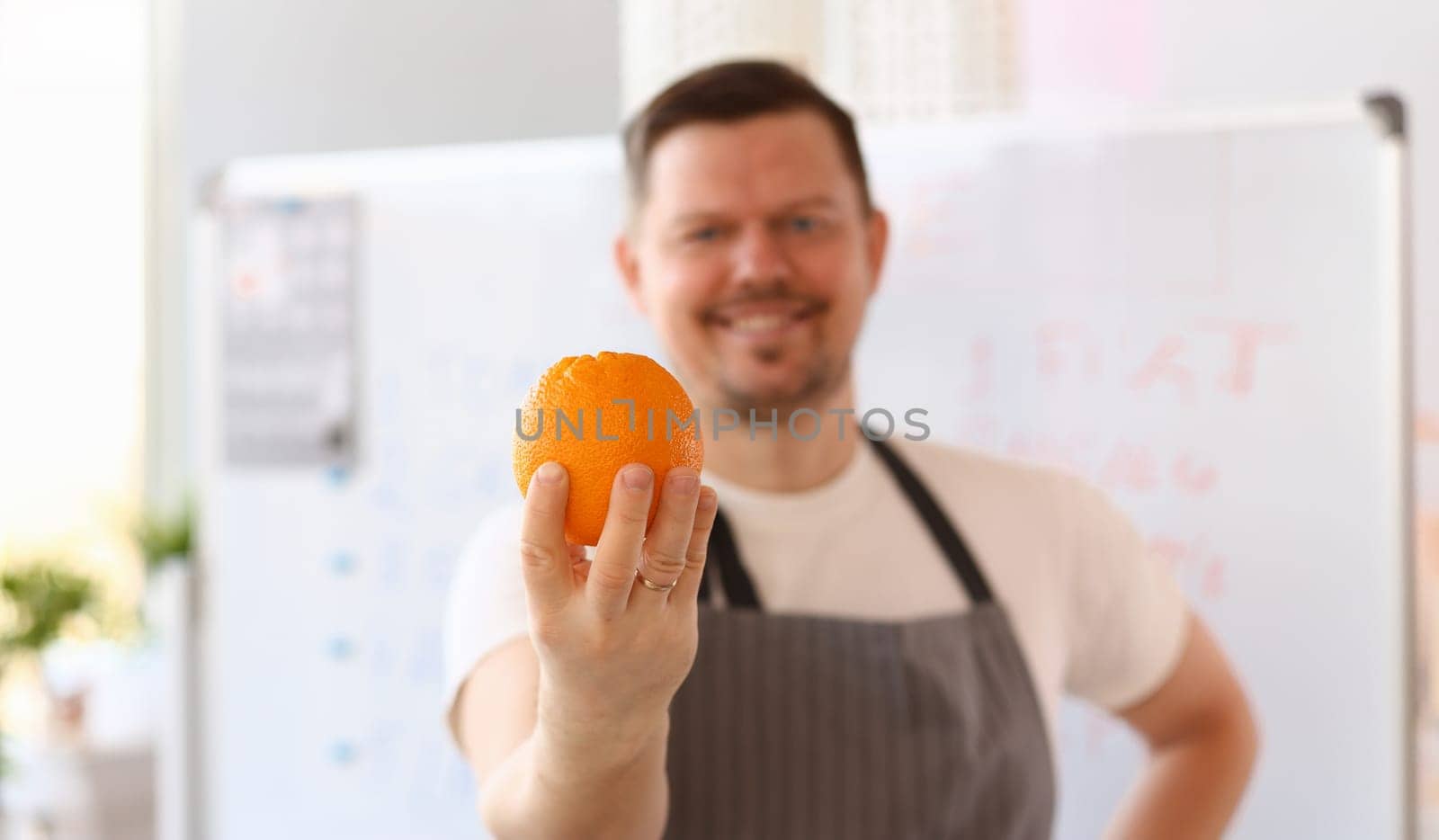 Smiling Chef Vlogger Holding Orange Ingredient by kuprevich