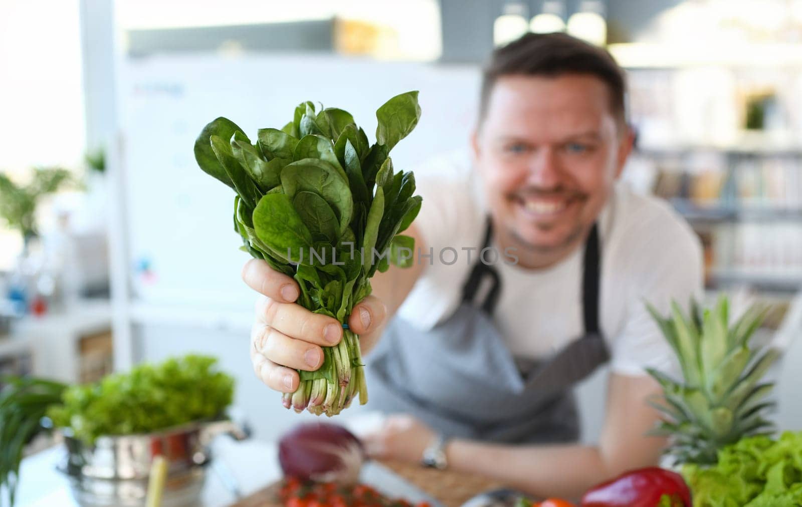 Male Hand Holding Green Washed Sorrel Herb Bunch by kuprevich