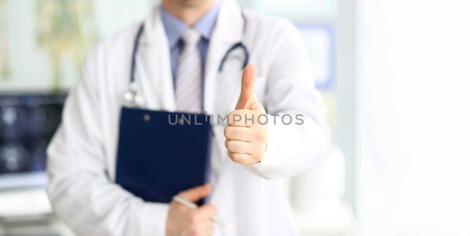 Male doctor show thumb up sign as public opinion expression for good treatment closeup