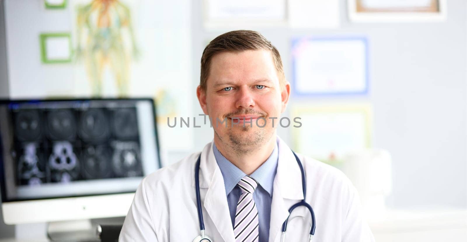 Adult smiling gp looking in camera in office portrait