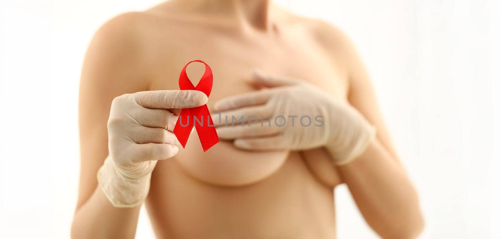 Woman Breasts Anti Cancer Ribbon Campaign Portrait. Preventing Female Breast Oncology Disease. Naked Bust on White Background. Fight Feminine Illness. Beautiful Girl Body Partial View Shot