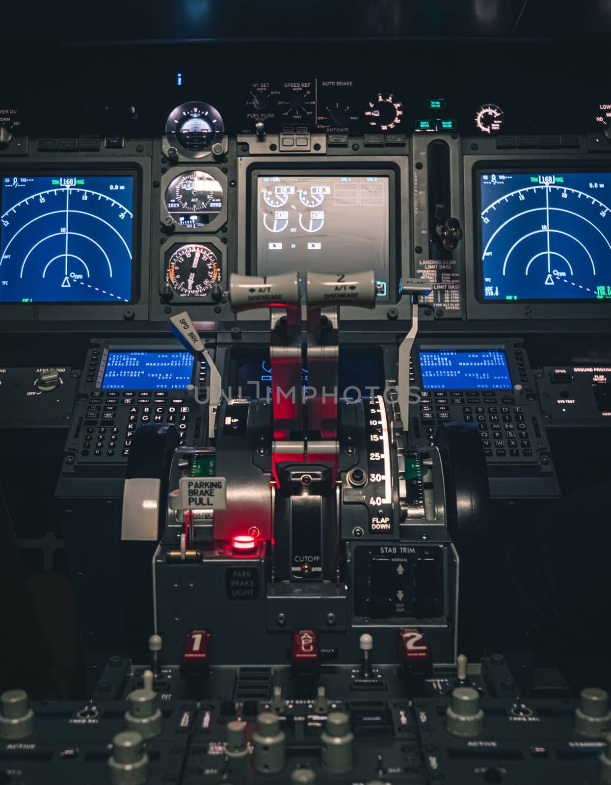 Cockpit view of an airplane during a night-time flight with illuminated instrument panels