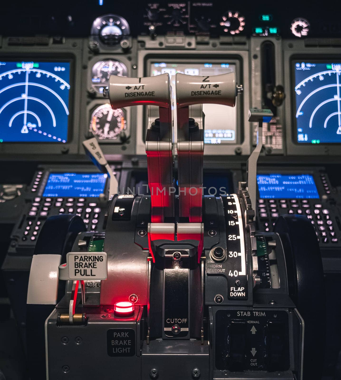 Cockpit view of an airplane during a night-time flight with illuminated instrument panels by Busker