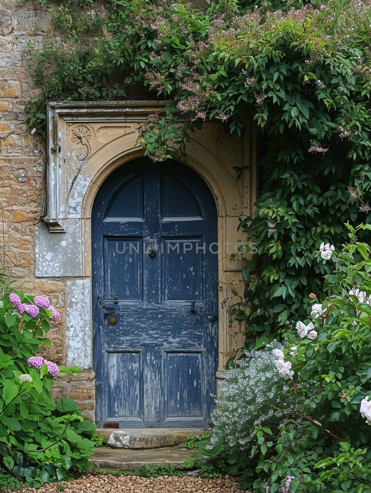 Entrance to a historic manor, framed by antique architectural elements and flanked by potted topiaries, features an aged door, the surrounding ivy and stonework add to the timeless elegance of the property