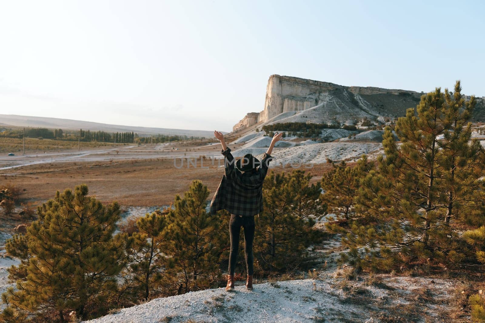 triumphant hiker soaking in majestic mountain view from rocky summit