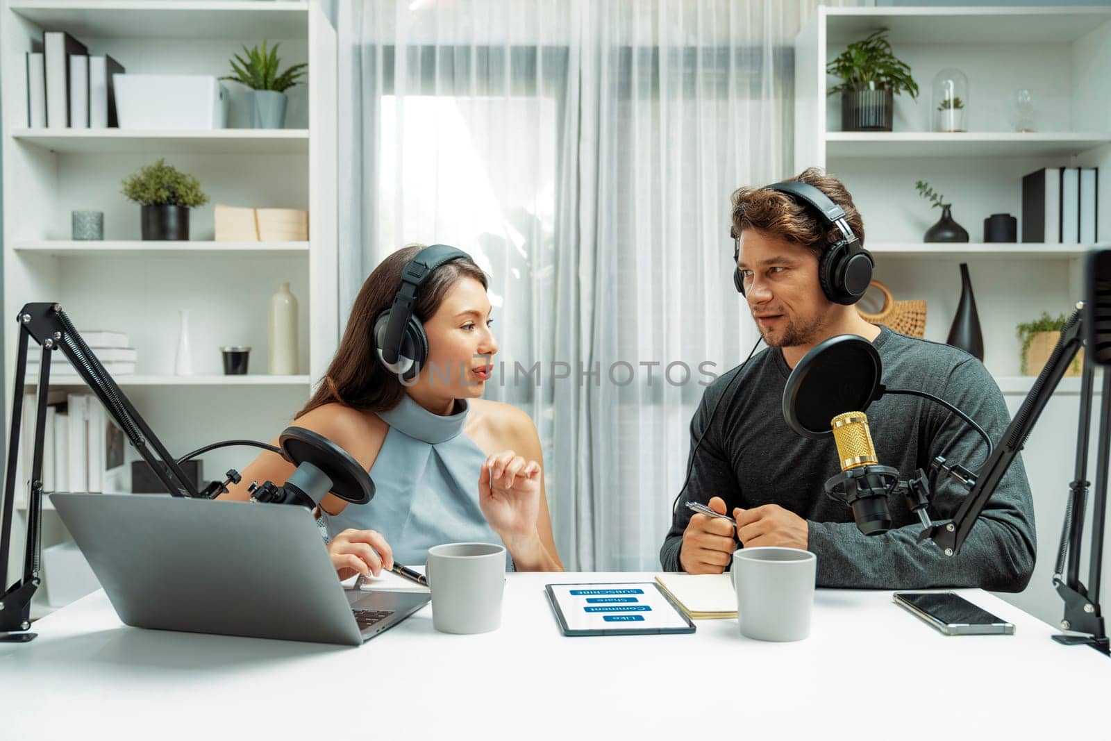 Host channel broadcasters discussing together, making advice for problem in live streaming with listeners surrounded sets of live streaming on radio talking show at comfy modern workplace. Postulate.