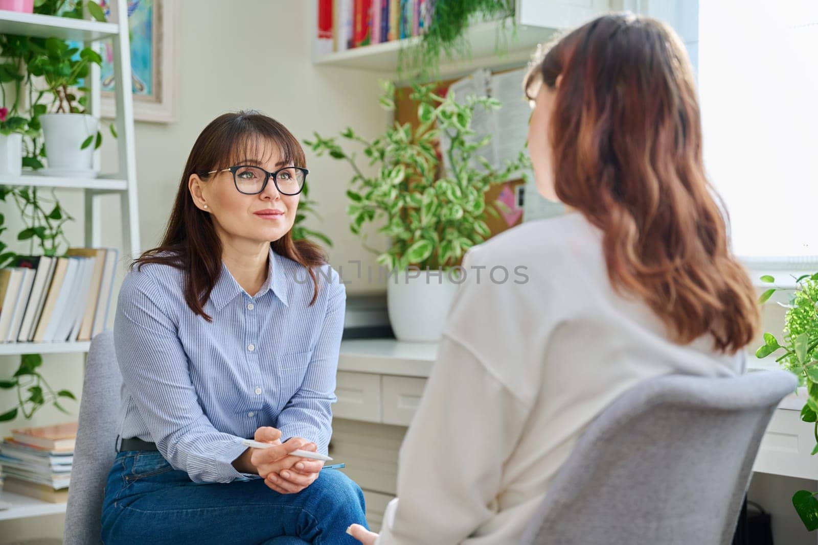 Female psychologist psychotherapist therapist counselor social worker talking working with young woman, meeting session therapy in office. Mental health, psychology psychotherapy counseling, youth